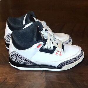 White and Black Sneakers with Red Accents